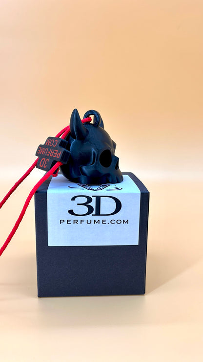 Black skull-shaped perfume bottle with red accents on a 3D Perfume.com box against a beige background