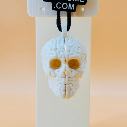 3D printed skull-shaped perfume bottle on a stand with '3D Perfume Com' label.